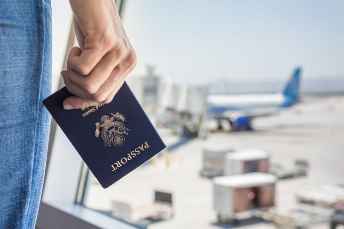 Traveler holding a United States passport at the airport. Traveler holding a United States passport at the airport.