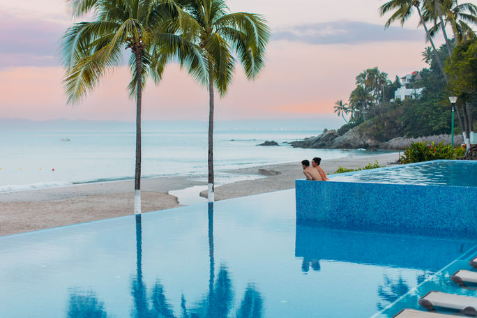 A couple enjoying the pool at the Hyatt Ziva Puerto Vallarta.