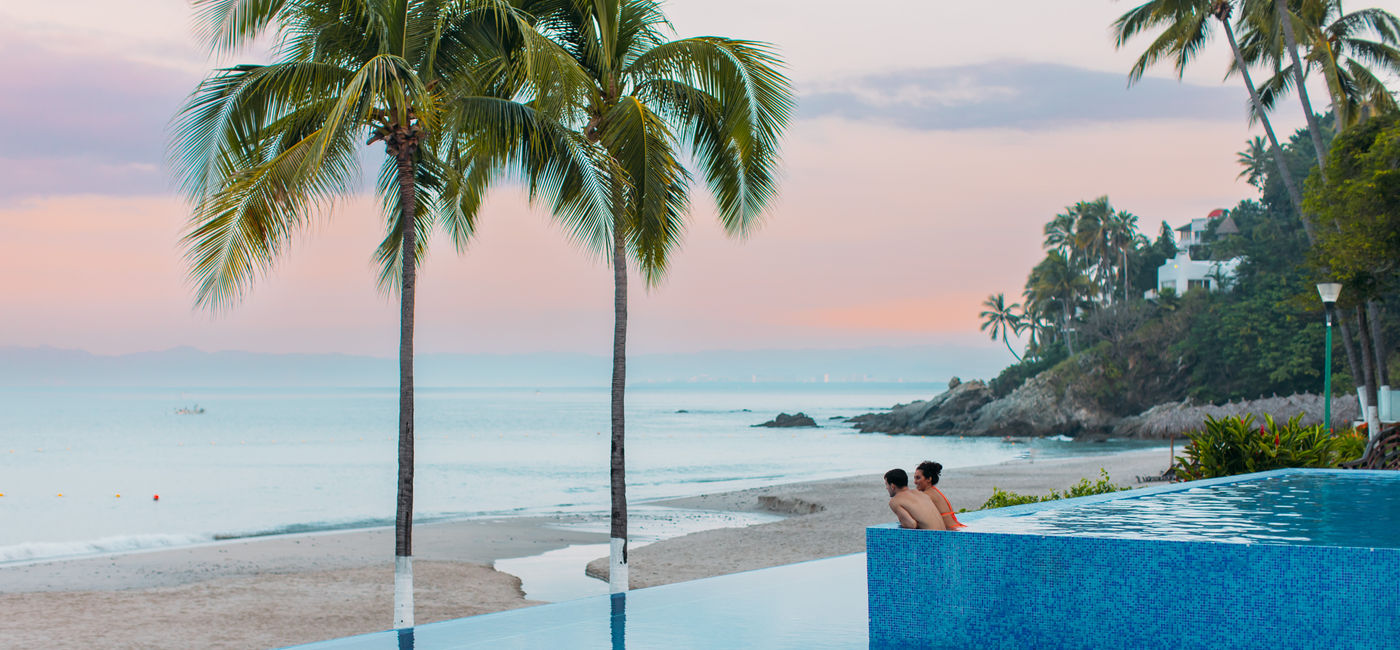 Image: A couple enjoying the pool at the Hyatt Ziva Puerto Vallarta. (Photo Credit: Inclusive Collection)