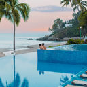 A couple enjoying the pool at the Hyatt Ziva Puerto Vallarta.