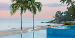 A couple enjoying the pool at the Hyatt Ziva Puerto Vallarta.