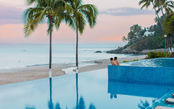 A couple enjoying the pool at the Hyatt Ziva Puerto Vallarta.