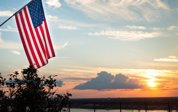 Bright american flag flying above beautiful sunset over Mississippi river