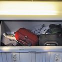 Carry-on luggage in the overhead bin