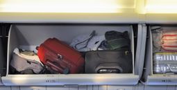 Carry-on luggage in the overhead bin