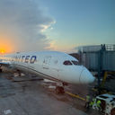 The sun sets behind a United Airlines plane parked at Chicago's O'Hare International Airport