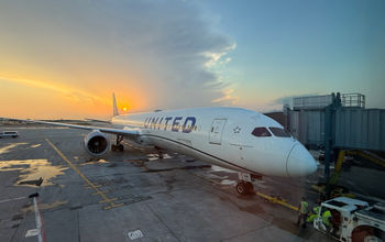 The sun sets behind a United Airlines plane parked at Chicago's O'Hare International Airport