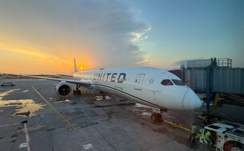 The sun sets behind a United Airlines plane parked at Chicago's O'Hare International Airport