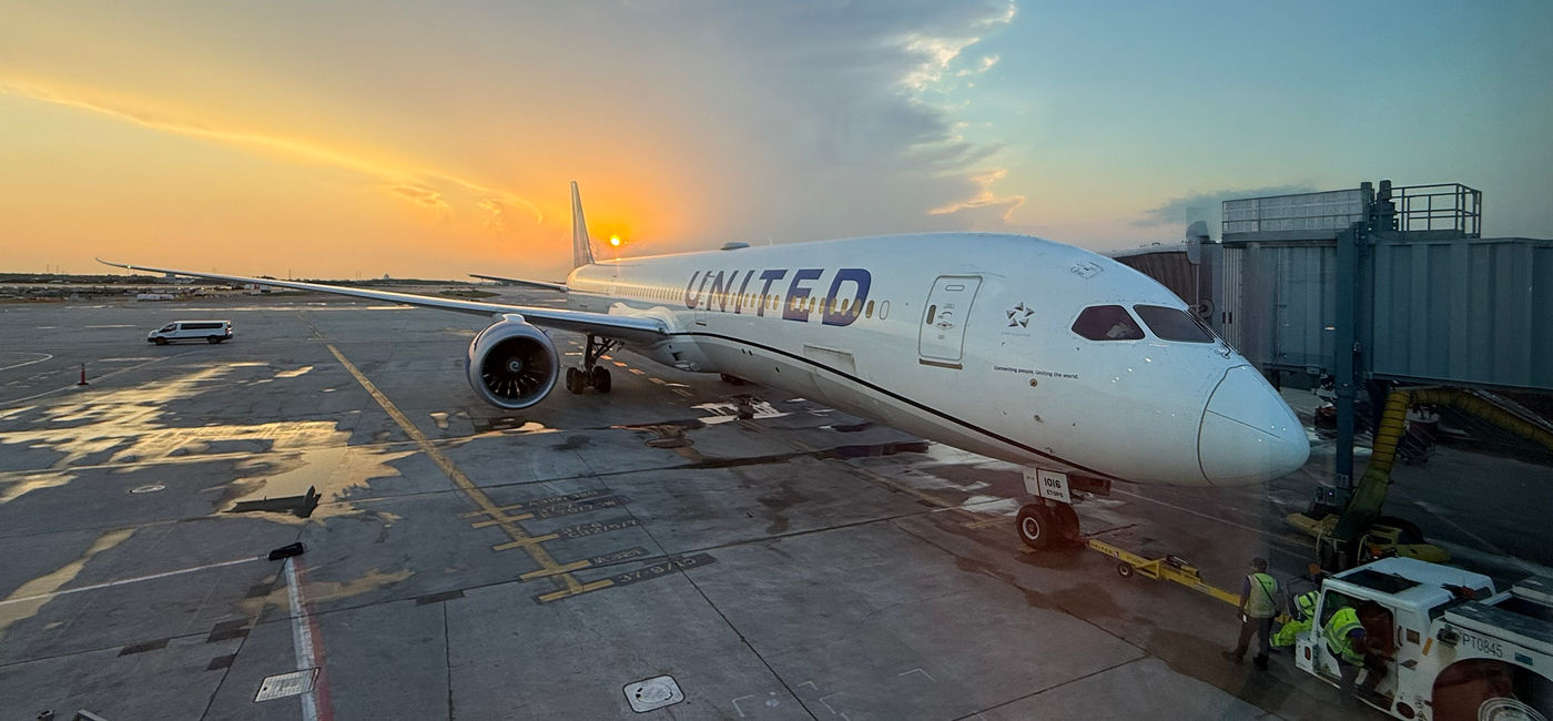 Image: The sun sets behind a United Airlines plane parked at Chicago's O'Hare International Airport. (Photo Credit: Photo by Paul J. Heney.)