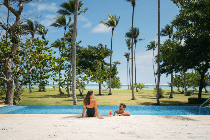 A couple at the Club Pool at Wyndham Alltra Samana