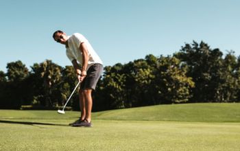 Man golfing at a Hard Rock golf club