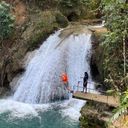 Leaping off a cliff into the Island Gully Falls Blue Hole in Ocho Rios.
