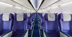Empty passenger airplane seats in cabin.