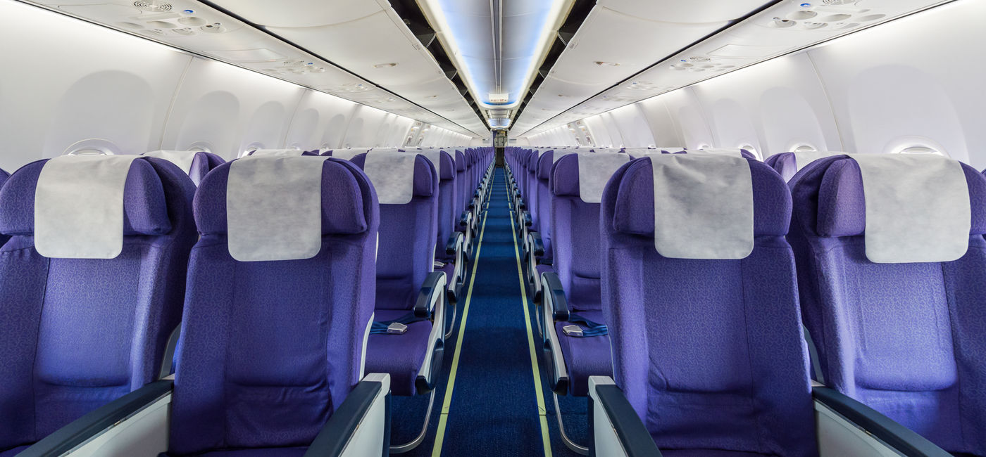 Image: Empty passenger airplane seats in cabin. (Photo Credit: sattapapan tratong / Adobe Stock)