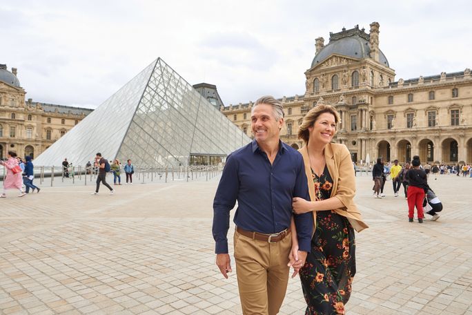 A couple enjoys an excursion to The Louvre on a Seine River cruise with AmaWaterways. AmaWaterways, travelers in Paris, river cruise guests, river cruise travelers, seine river