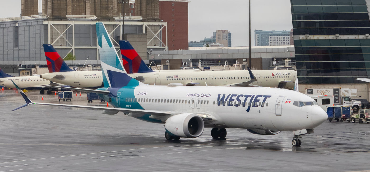 Image: WestJet Boeing 737-8 MAX at Boston Logan International Airport (BOS). (Photo Credit: Wangkun Jia / Adobe Stock)