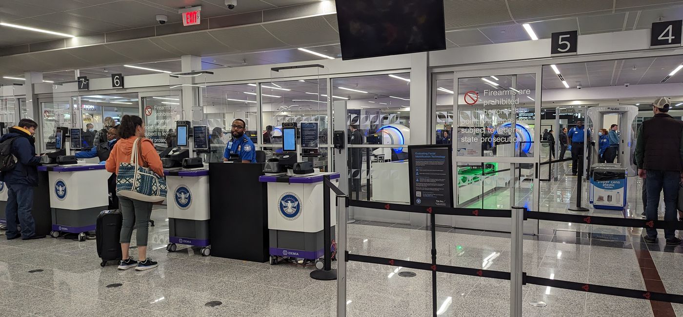 Image: A traveler checks in with TSA security. (photo by Eric Bowman)
