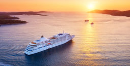 Cruise ship sailing into sunset