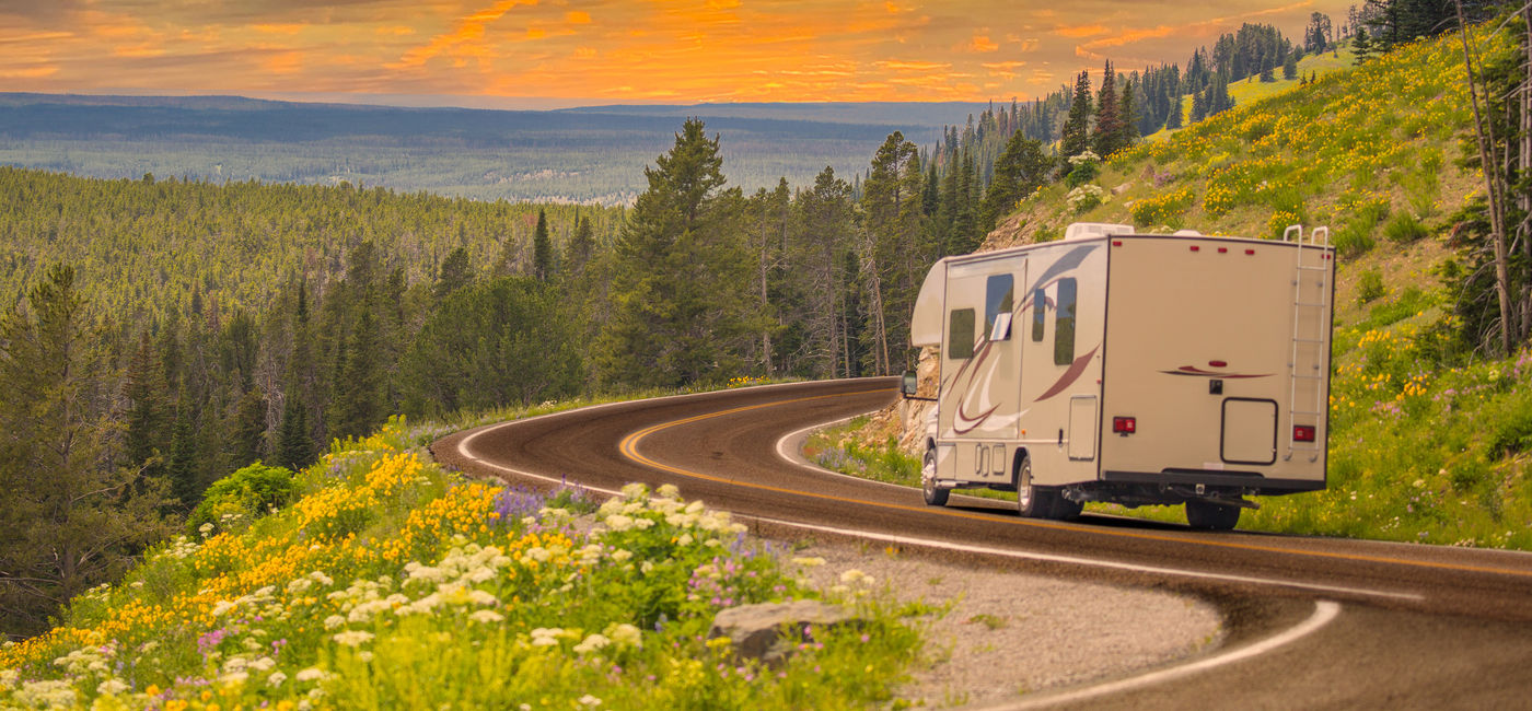 Image: RV driving down rural road.  (Photo Credit: Andy Dean / Adobe Stock)
