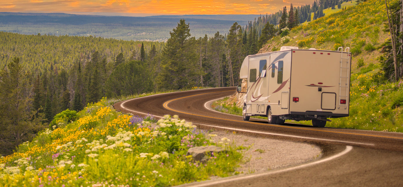 Image: RV driving down rural road. (Photo Credit: Andy Dean / Adobe Stock)
