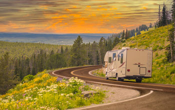 RV driving down rural road. 