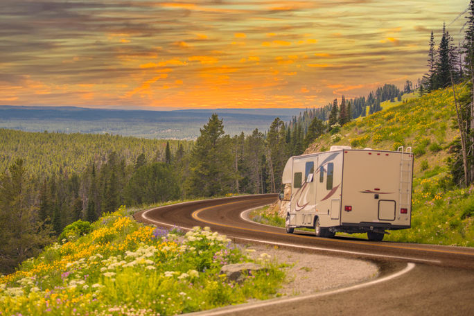 RV driving down rural road. RV driving down rural road.