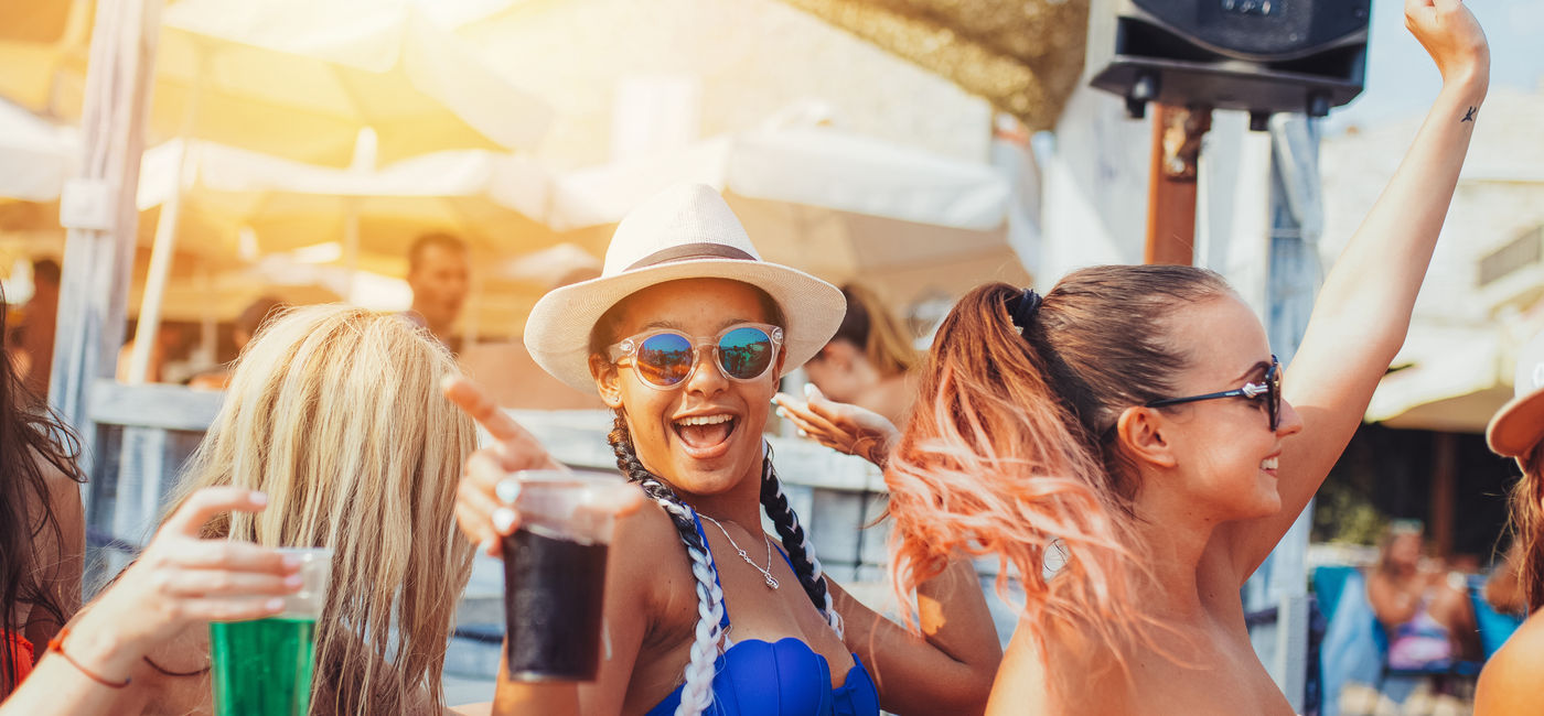 Image: Spring Breakers partying on the beach. (Photo Credit: Adobe Stock/likoper)
