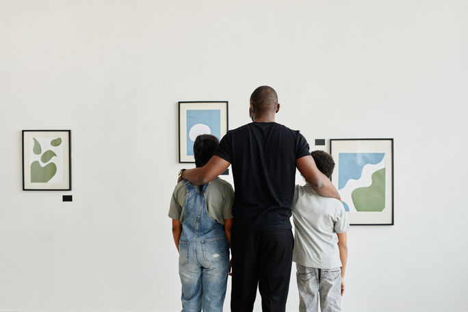 Family enjoying exhibit at an art museum. 