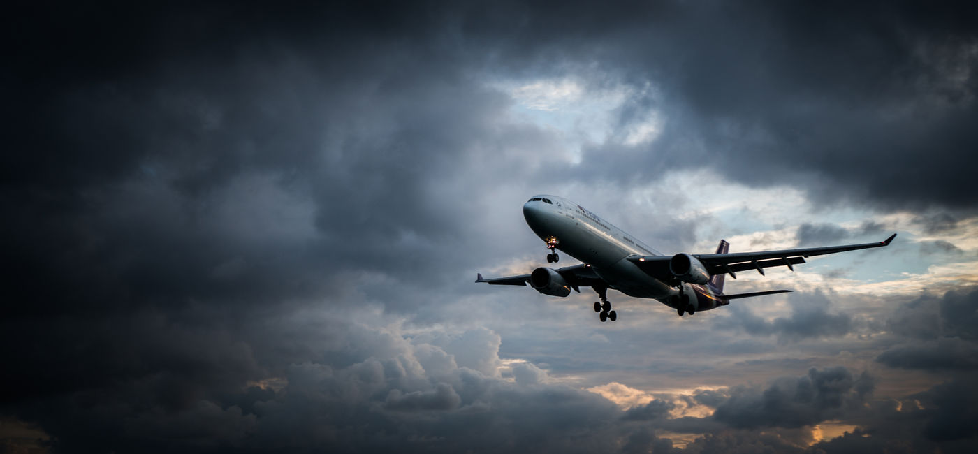 Image: Plane flying in a storm. (Photo Credit: Adobe Stock/stryjek)