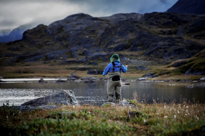 A fly fisherman enjoying the day on the Erfalik River in Greenland.