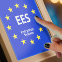 Woman using an EES self-service kiosk.