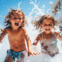Kids playing in a cruise ship's pool area.