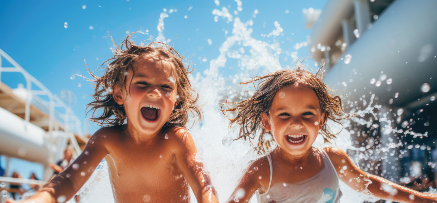 Image: Kids playing in a cruise ship's pool area. (Photo Credit: Adobe Stock/Microgen)