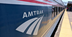 Amtrak logo on the side of a train.