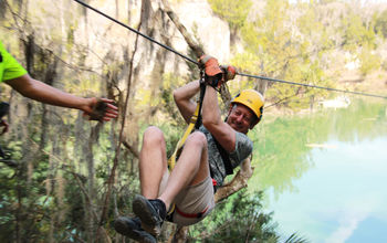 The author on a zip line at Canyons Zip Line and Adventure Park