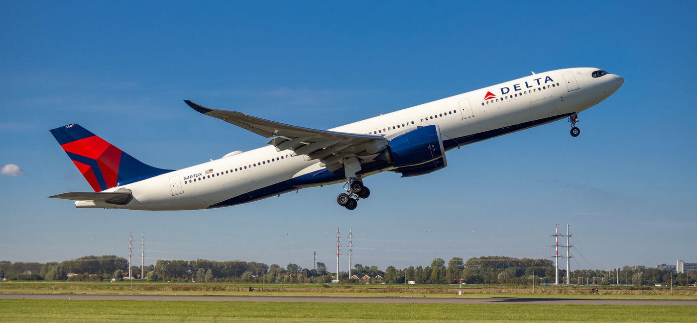 Image: Delta Air Lines plane taking off from Amsterdam's Schiphol Airport. (Photo Credit: Adobe)