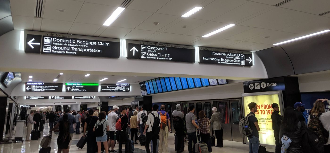 Image: A crowd of people waiting to board a tram at the Atlanta airport (photo by Eric Bowman)