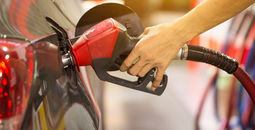 Pumping gas at gas pump.