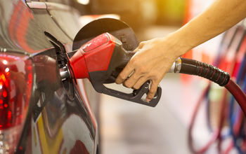 Pumping gas at gas pump.
