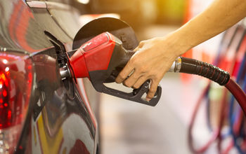 Pumping gas at gas pump.