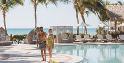 A couple at the main pool at Sanctuary Cap Cana