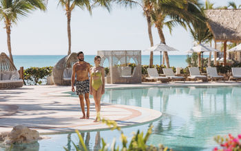A couple at the main pool at Sanctuary Cap Cana