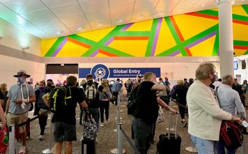 A view of Global Entry kiosks through a long line at Dallas Fort Worth airport