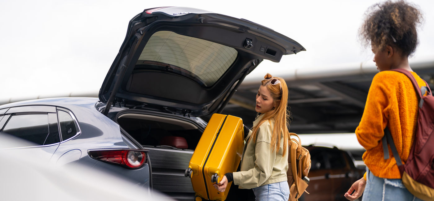 Image: Traveler checking into a rental car. (Photo Credit: Adobe/CandyRetriever)