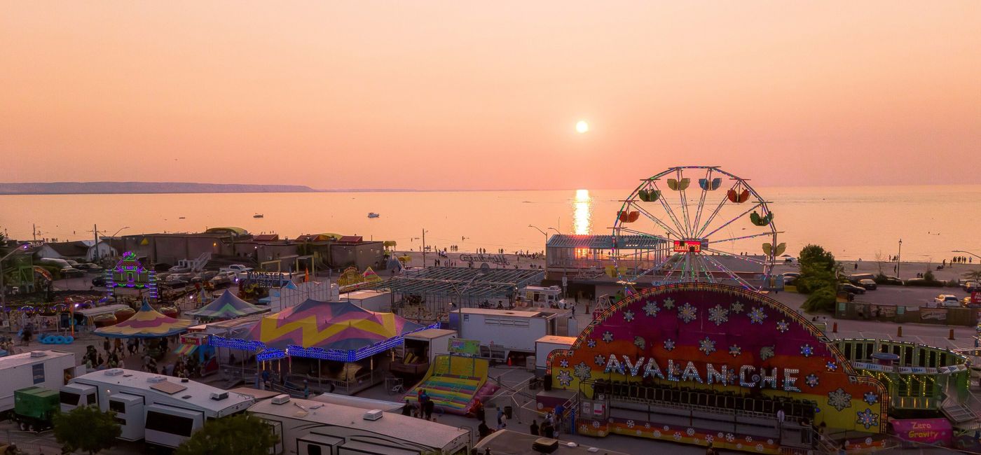 Image: The sun goes down at Wasaga Beach during the Town's annual midway. (Photo Credit: Town of Wasaga Beach)