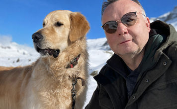 Philippe Benoist, founder of MyDogCanFly.com, with golden retriever, Bailey.