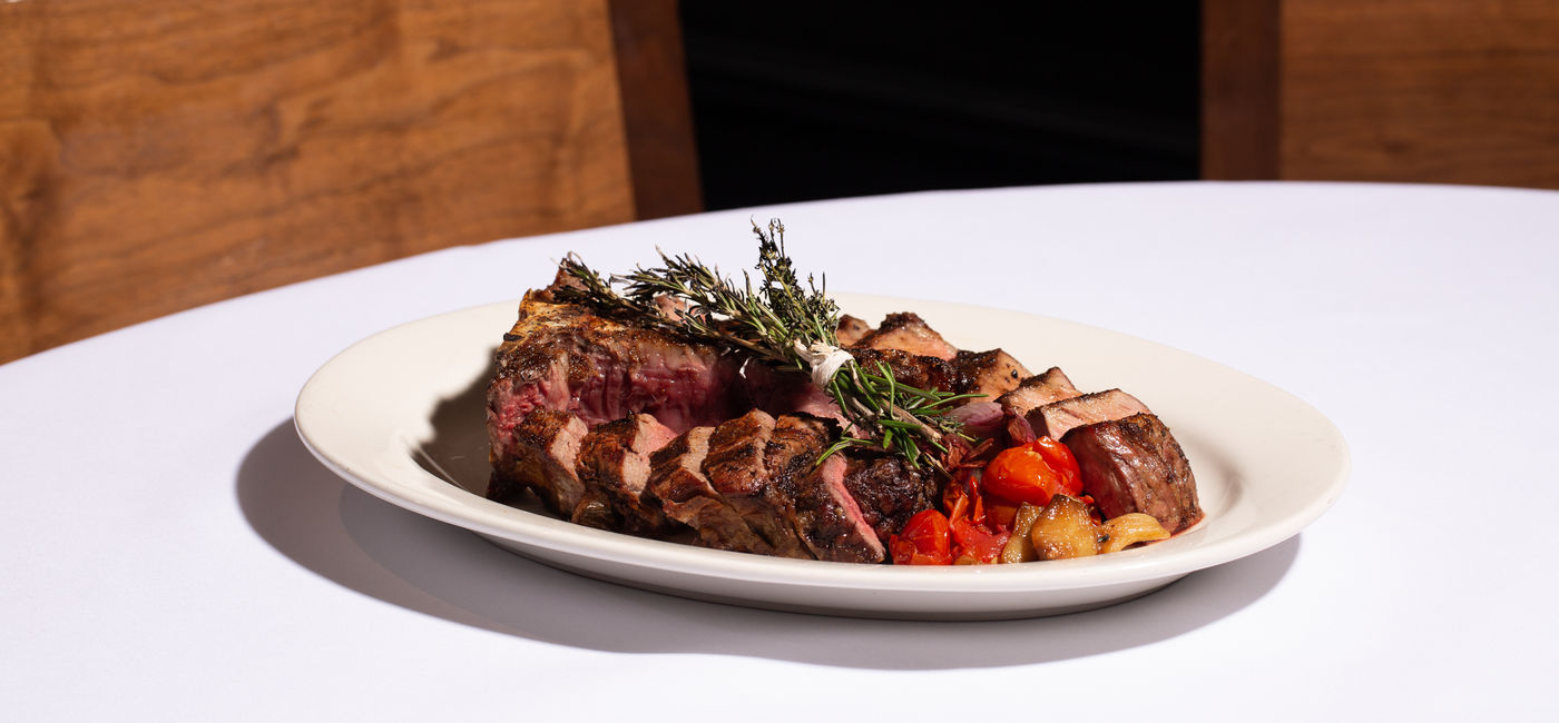 Image: Grilled tomahawk steak at a fine dining restaurant. (Photo Credit: Adobe/Kathryn)