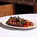 Grilled tomahawk steak at a fine dining restaurant