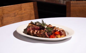Grilled tomahawk steak at a fine dining restaurant