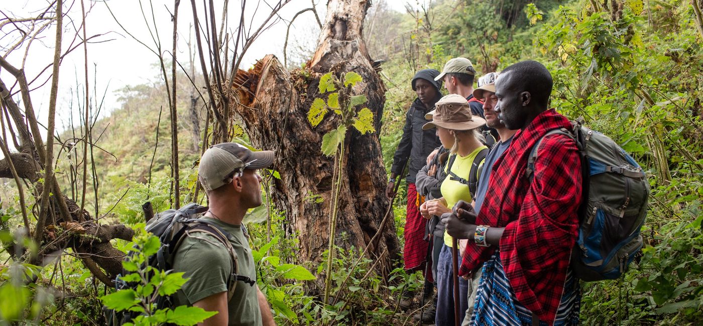Image: Travelers explore Tanzania’s Great Rift with a member of the Masai tribe. (Photo Credit: Leonotis Adventures/Audley Travel)